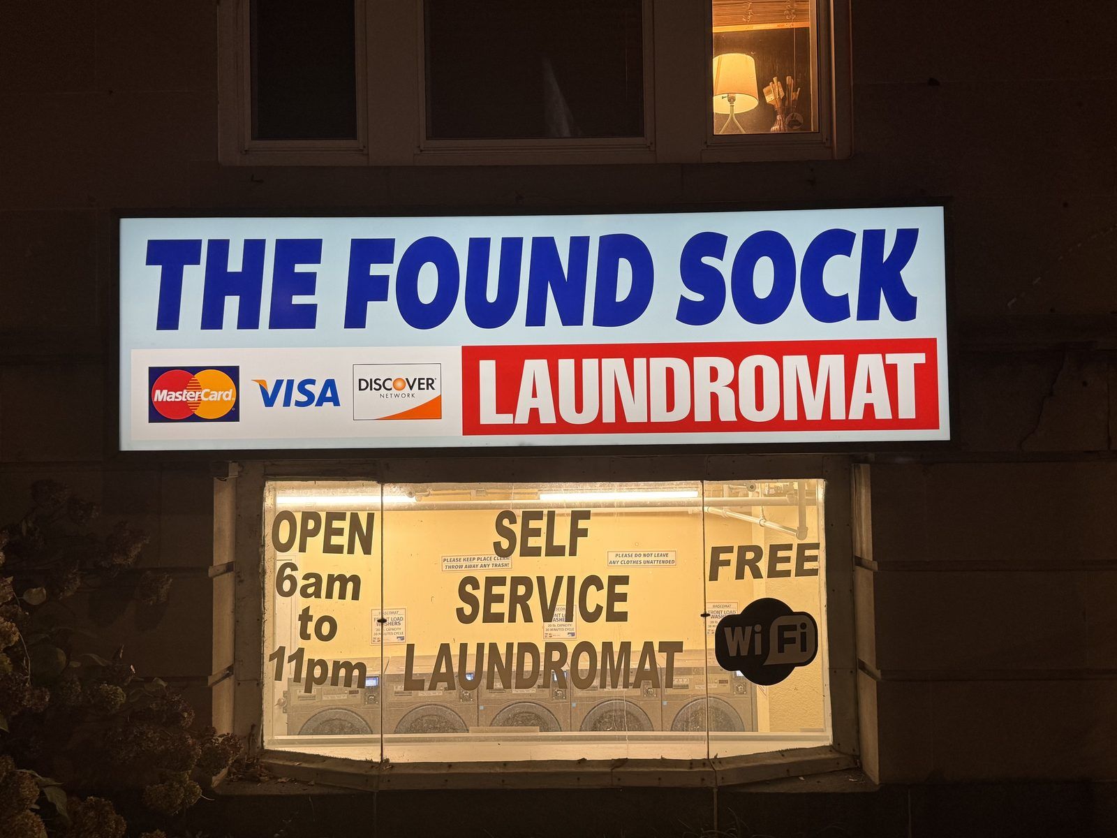 The Found Sock Laundromat sign — close-up